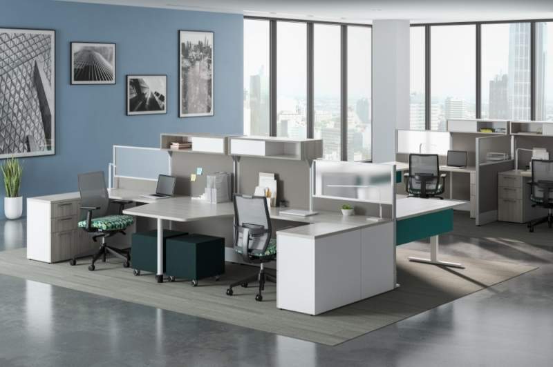 Cubicles side to side with a light blue wallpaper