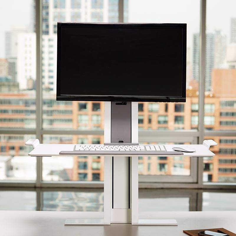 Keyboard and monitor stand sitting on a desk